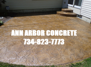 Picture of stamped concrete patio with Ann Arbor Concrete name and phone number.